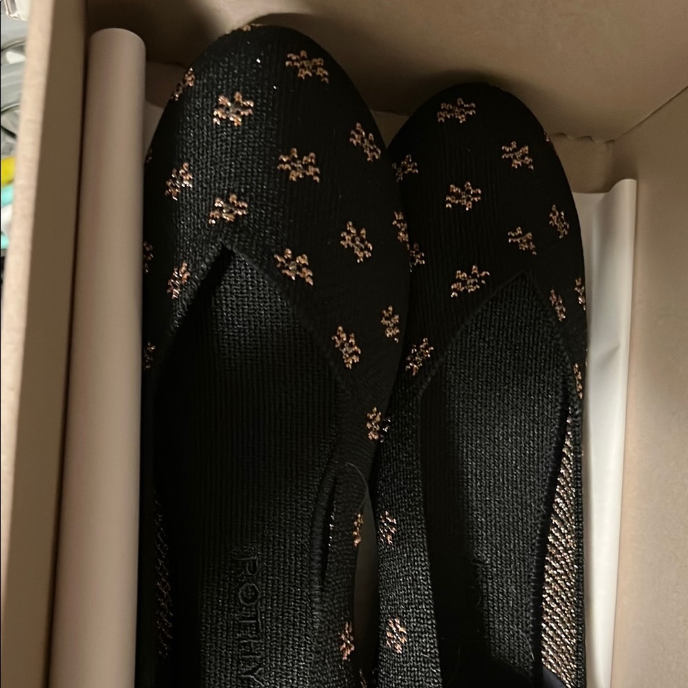 Rothy's Black and Gold Flats with Elegant Design